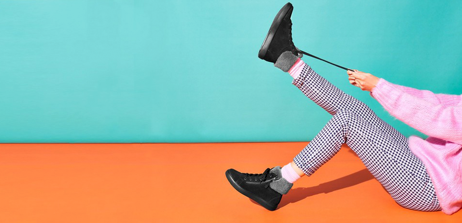 Hotter Shoes' brightly coloured image with person tying their laces