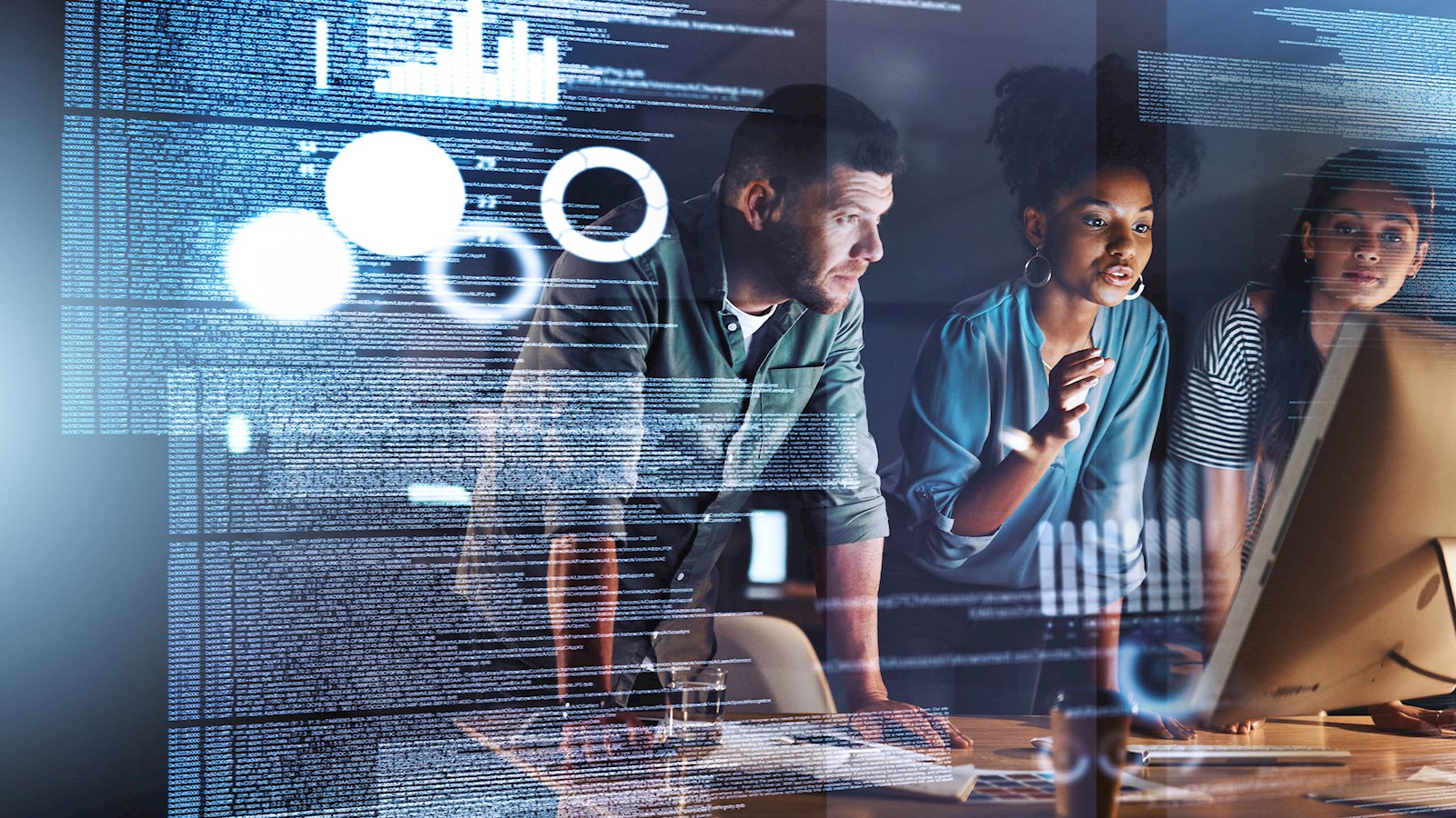 3 people looking at numbers on a screen 